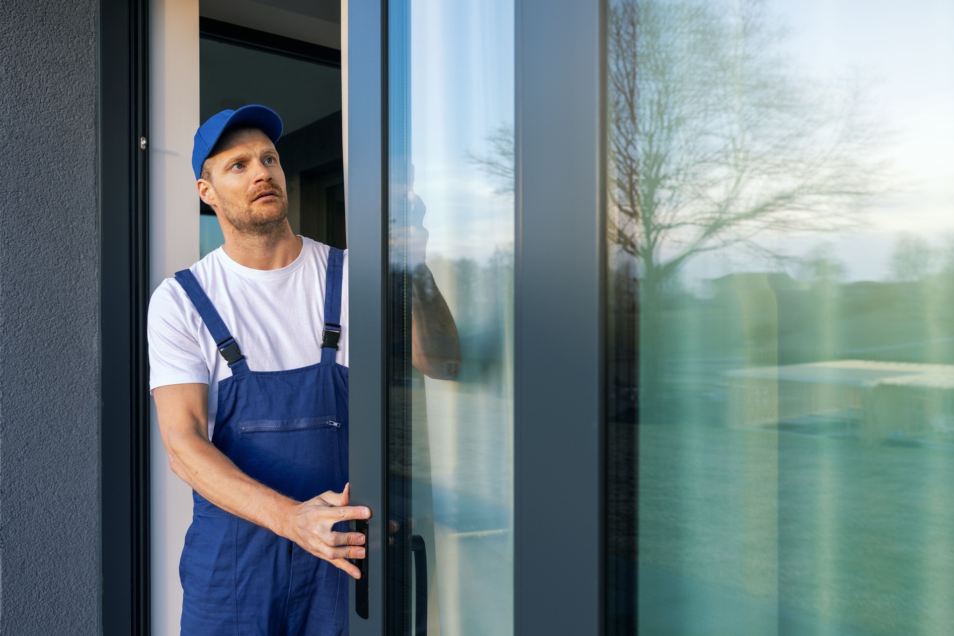 man installing aluminium frame sliding terrace doors
